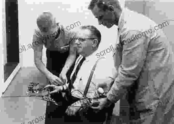 Image Of The Milgram Experiment Setup, With The Participant On The Left And The Learner On The Right, With Electrodes Attached To The Learner's Arm. Understanding Ourselves: A Review Of 17 More Psychology Experiments And Concepts